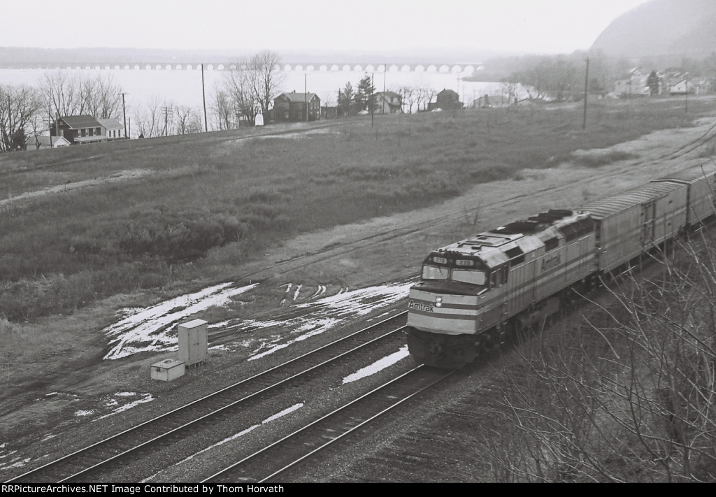 An Amtrak train passes by a vacant area that was once home to a PRR facility